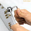 A hand is holding a silver manual riveting tool set with various rivets and a handle.