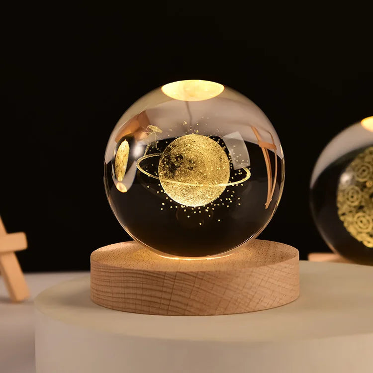 A spherical glass orb with a glowing golden sphere inside, resting on a wooden base.