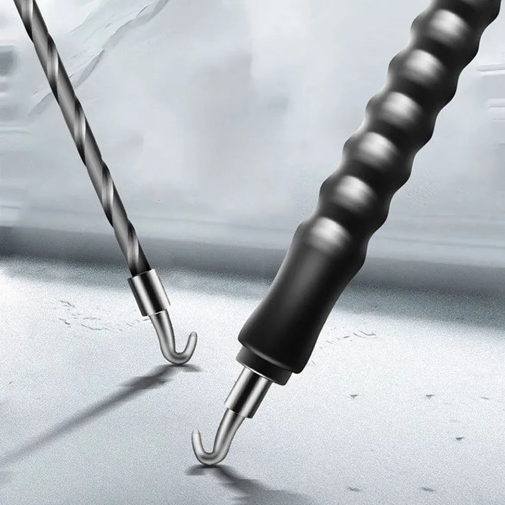A close-up view of a black automatic rebar tie wire twister tool with silver tips resting on a light surface.