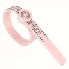 A pink precision ring measuring tool with a magnifying display and numbered scale.