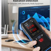A hand holds a blue and black radio frequency detection device while monitoring signals on a computer screen.