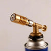 A brass gas torch with a textured nozzle and fitting is shown against a light background.