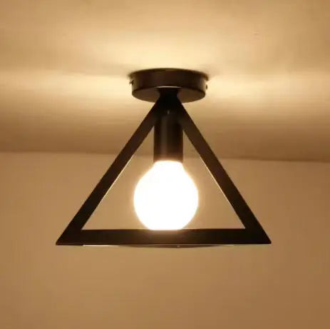 A black triangular chandelier lamp with an exposed light bulb hanging from a ceiling.