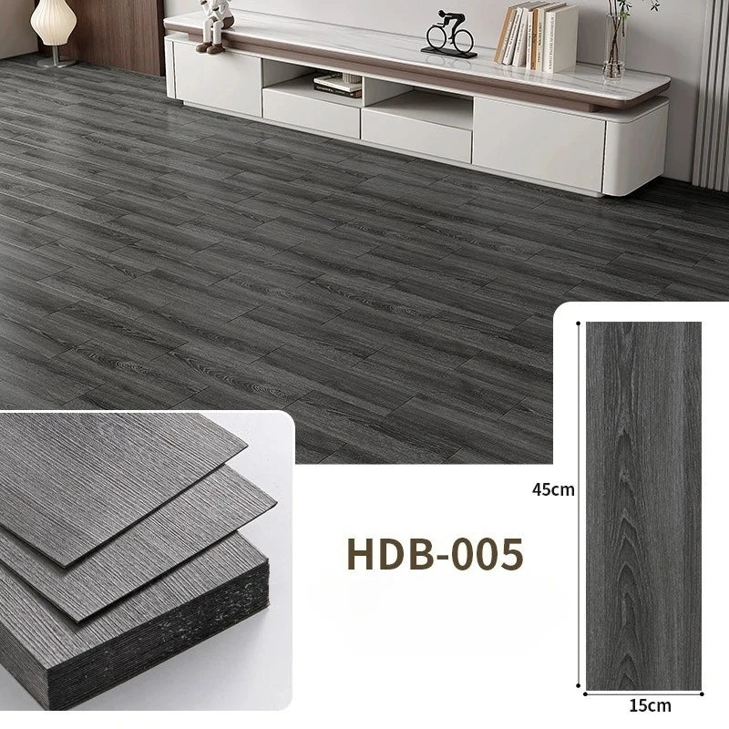 Close-up view of dark gray wood grain floor tiles and a sample piece showing the texture.