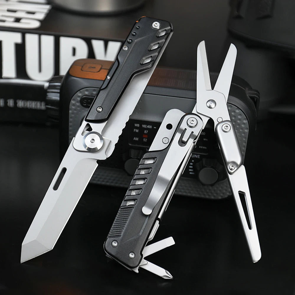 A silver compact multi-tool pocket knife set is displayed on a dark surface next to a black electronic device.