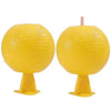 Two yellow sticky fruit fly traps with pink straws.