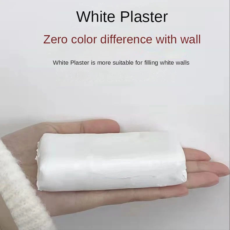 A hand holds a block of white plaster, demonstrating its use for filling white walls.