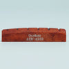 A wooden acoustic guitar bone bridge saddle with the name Guyker ATR-4359 engraved on it.