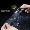 Hands are applying a piece of clear mounting tape onto a surface, with a roll of the same tape visible nearby.