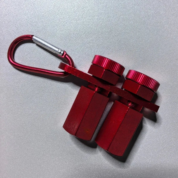 A red precision stair gauge framing square with a silver handle and cross-shaped body.