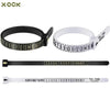 A set of black and white plastic rings used as a precision sizer for jewellery measurement.