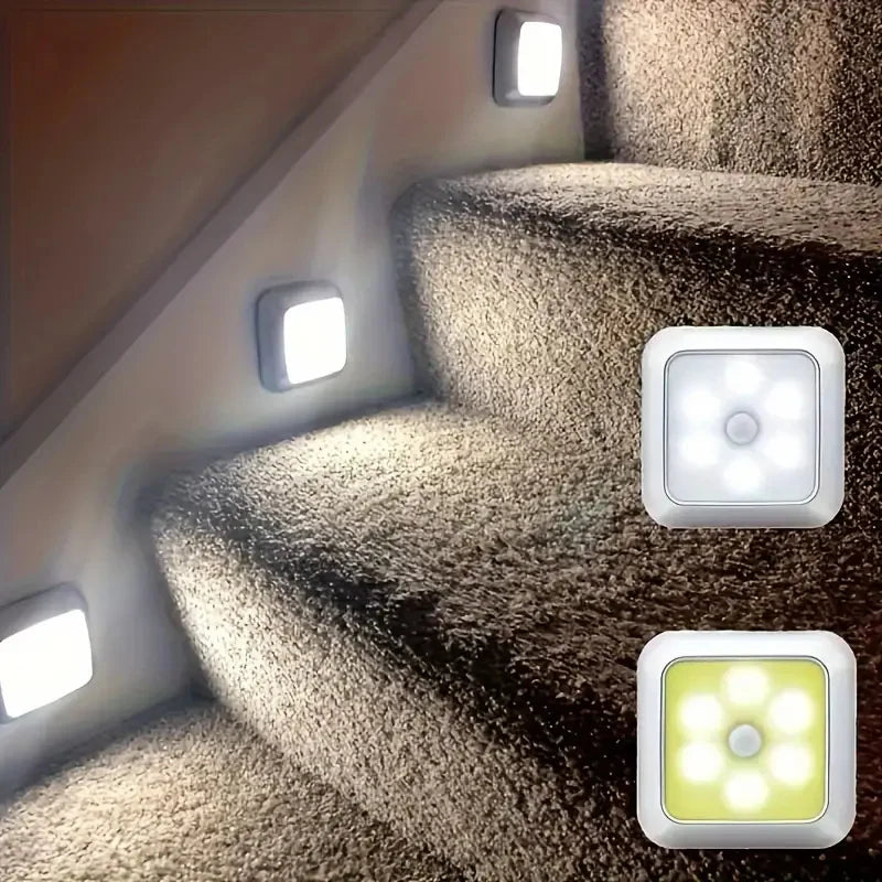 Automatic motion sensor night lights illuminating a textured staircase indoors.