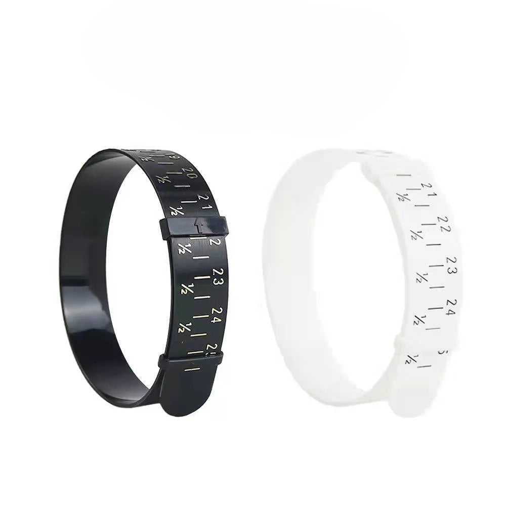 A black adjustable bangle sizer and measuring tool with white markings shown on a wrist.