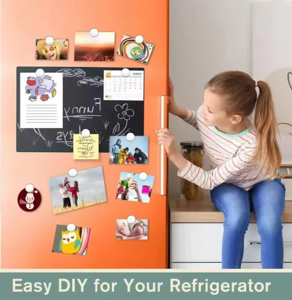 A girl is applying round magnetic fridge stickers to an orange refrigerator door.