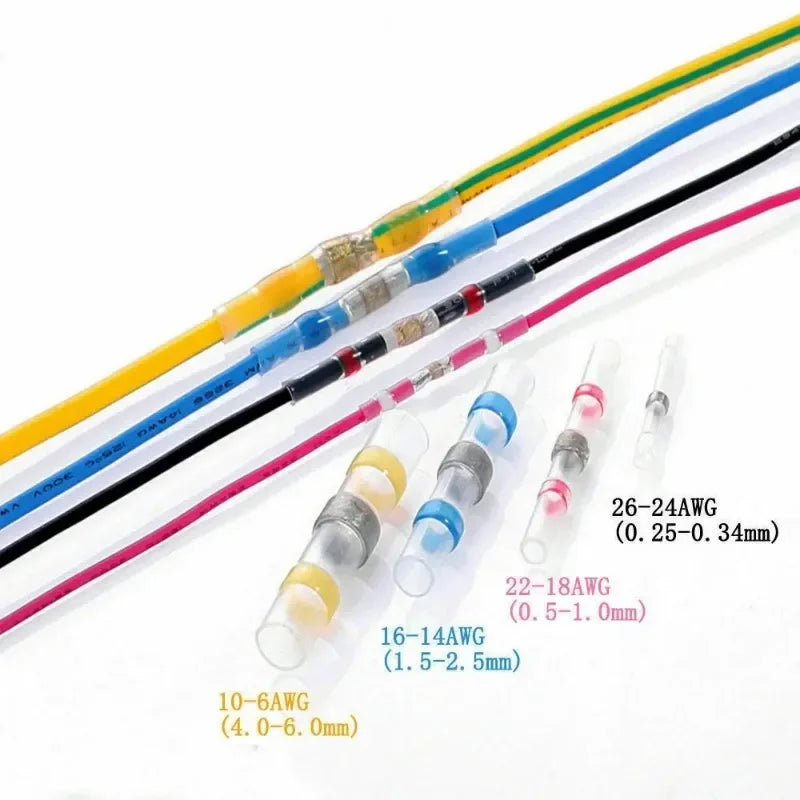 Colección de conectores de cable con retracción térmica de varios tamaños y colores, incluyendo amarillo, azul, negro y rosa.