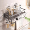 A metal shower caddy organizer rack mounted on a wall, holding various toiletries and a towel.
