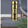 A gold-colored mini electric shaver with a Buddha design rests on a gray textured mat on a wooden surface.