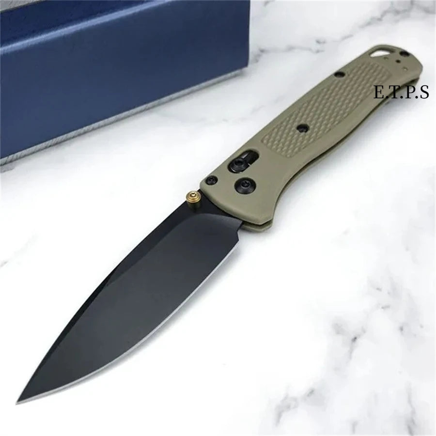 Un couteau EDC pliable avec une lame foncée et un manche beige clair, exposé sur un marbre blanc.