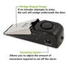 A black mini wireless door stop security alarm with a wedge-shaped design and sensitivity switch.