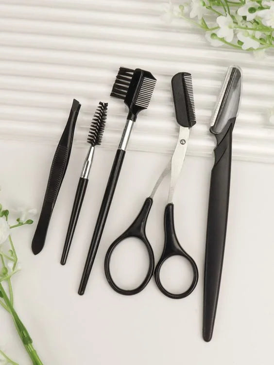 A set of professional eyebrow trimming tools including tweezers, brushes, and nippers arranged on a white surface.