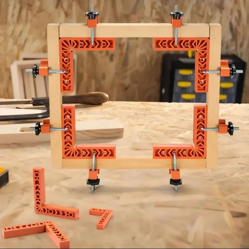A wooden frame with orange decorative elements and metal pins is shown, along with several small wooden pieces.