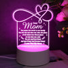 A glowing silhouette of a heart design on a clear acrylic night light featuring a message for Mom