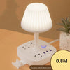 A white multi-functional conversion desk lamp with a shade and integrated USB and AC power outlets.