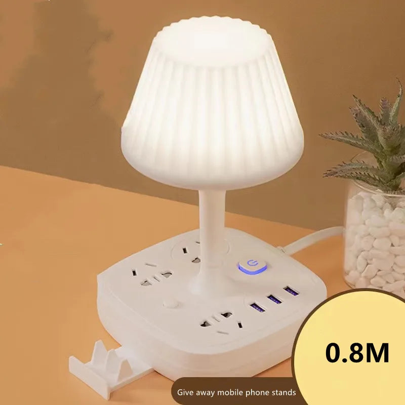 A white multi-functional conversion desk lamp with a shade and integrated USB and AC power outlets.
