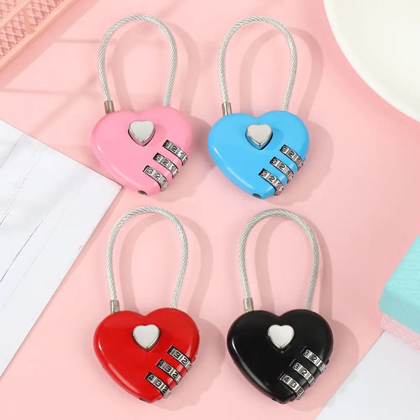 Three heart-shaped combination locks in pink, blue, and black are displayed on a pink background.