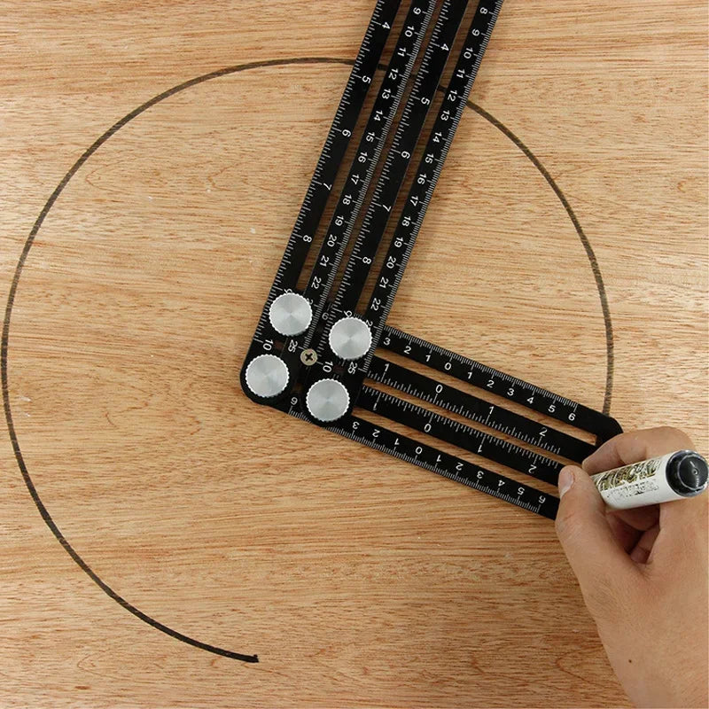 A hand holds a precision six-fold construction angle measuring ruler placed on a wooden surface.