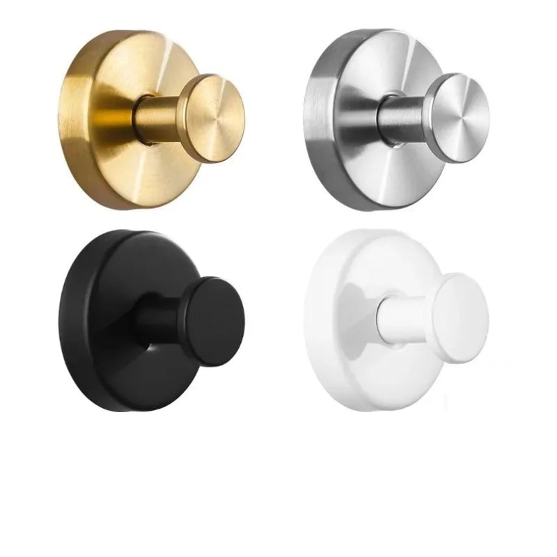 Three suction cup hooks in brass, silver, and matte black finishes.