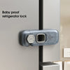 A baby proof refrigerator lock, a clear plastic latch with a 360-degree turn mechanism, attached to a silver refrigerator doo