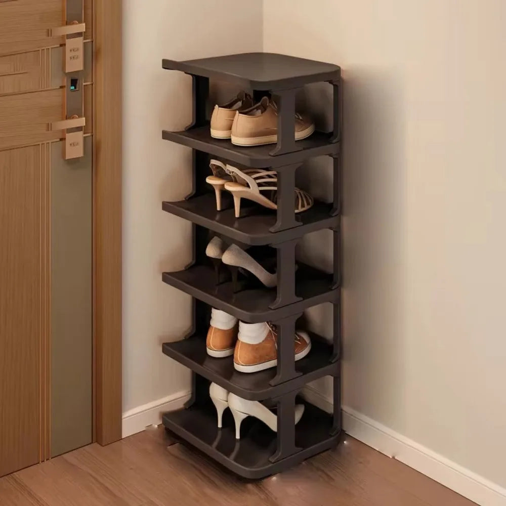 A dark brown stackable vertical shoe rack organizer mounted on a wall.
