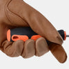 A hand wearing brown leather gardening pruning gloves holding a black and orange tool.