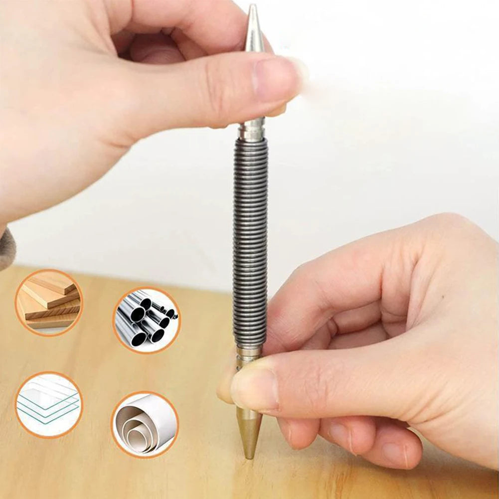 A hand is holding a dual-head spring nail set, demonstrating its use for precision fixing on wood.