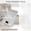 A silver water resistant panel kitchen scale is shown dripping water under a faucet.