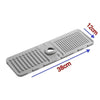 A gray silicone sink drain mat with ribbed texture, measuring 38cm long and 12cm wide.