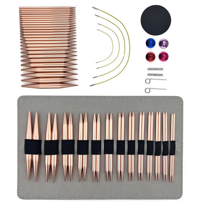 A set of interchangeable aluminum knitting and crochet needles in various sizes and colors displayed on a gray surface.