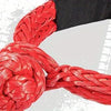 A close-up of a thick red synthetic winch rope coiled and wrapped around a black sleeve.