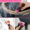 A hand uses a pink silicone adhesive removal scraper to scrape difficult objects from a dark surface.