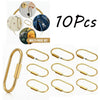 Ein Set aus zehn Messing-Gold-Schlüsselring-Karabiner und Tasche-Charms in verschiedenen Winkeln.
