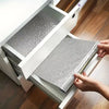 Hands are applying waterproof aluminum foil contact stickers to a white storage drawer.