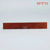 A rectangular piece of brown acoustic guitar bone bridge saddles labeled Guybox 5932
