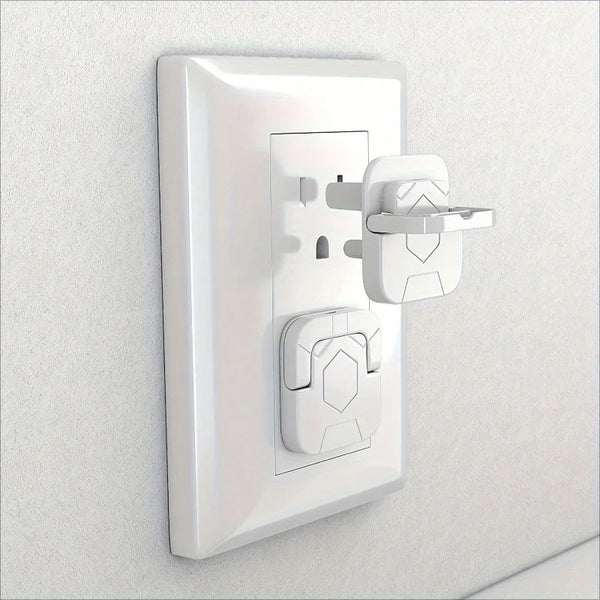 A white plastic outlet cover for baby proofing mounted on a wall.