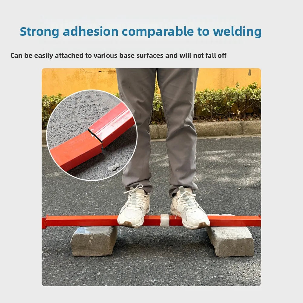 A person is demonstrating the strong adhesion of a red epoxy putty by attaching it to a metal rod on the ground.
