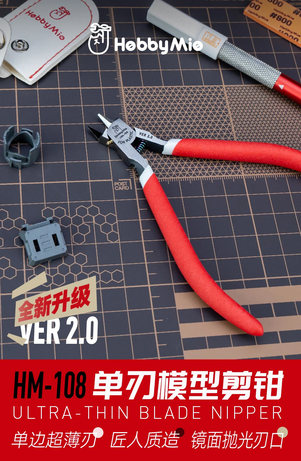 A close-up of an HM-108 ultra-thin blade nipper tool with red and silver handles, displayed on a dark surface.