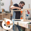 A man is using a precision right angle fixing clip on a wooden workbench.