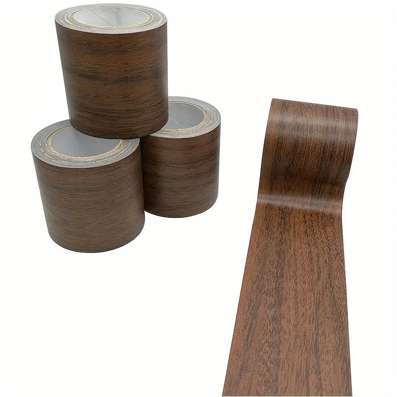 Rolls of faux wood grain repair tape in a dark brown color shown next to a long strip of the same material.