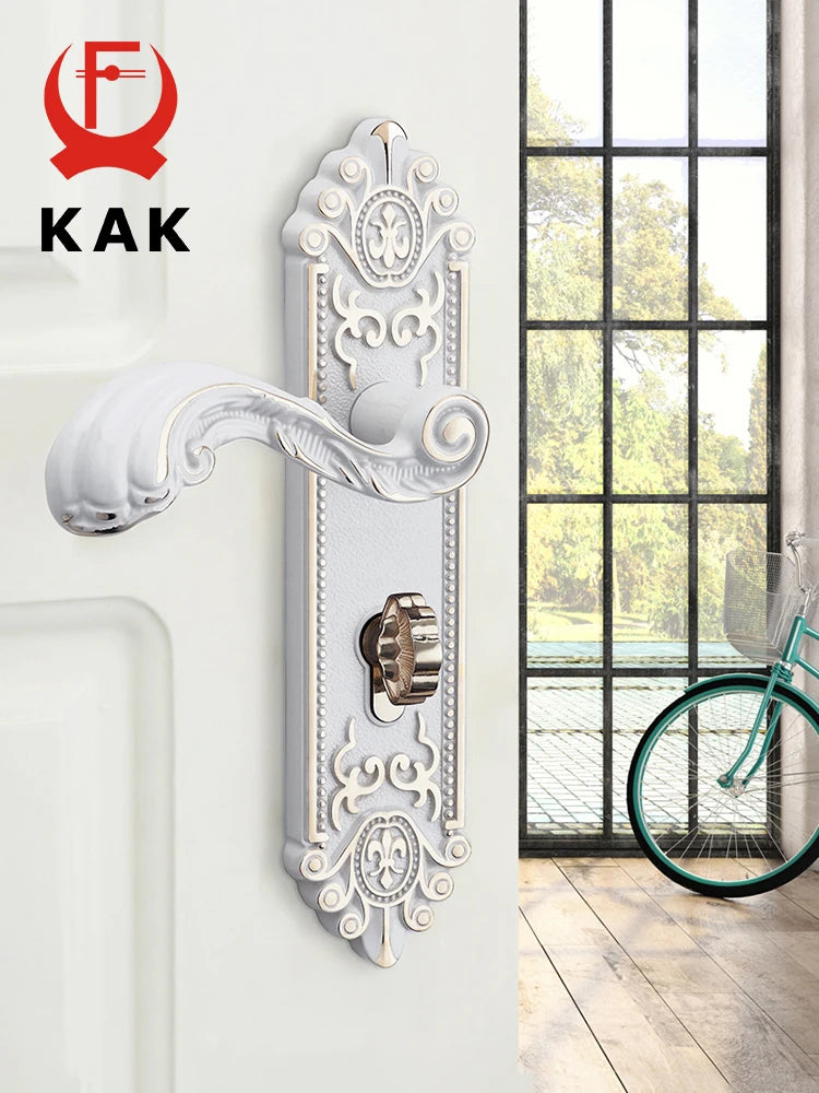 A decorative European style gold door lock with keys mounted on a white wall.