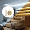Interior de sala con sofá y mobiliario de madera con iluminación LED sensor de movimiento integrado.